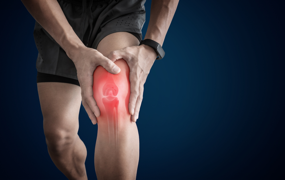 man suffering knee pain from overuse