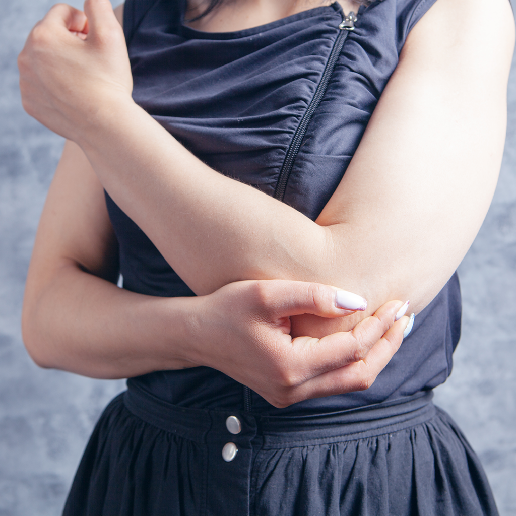 young woman suffering from elbow pain